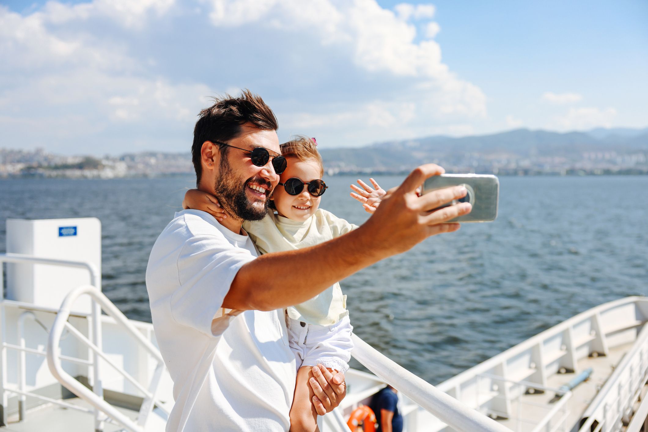 Father and child on deck taking a picture