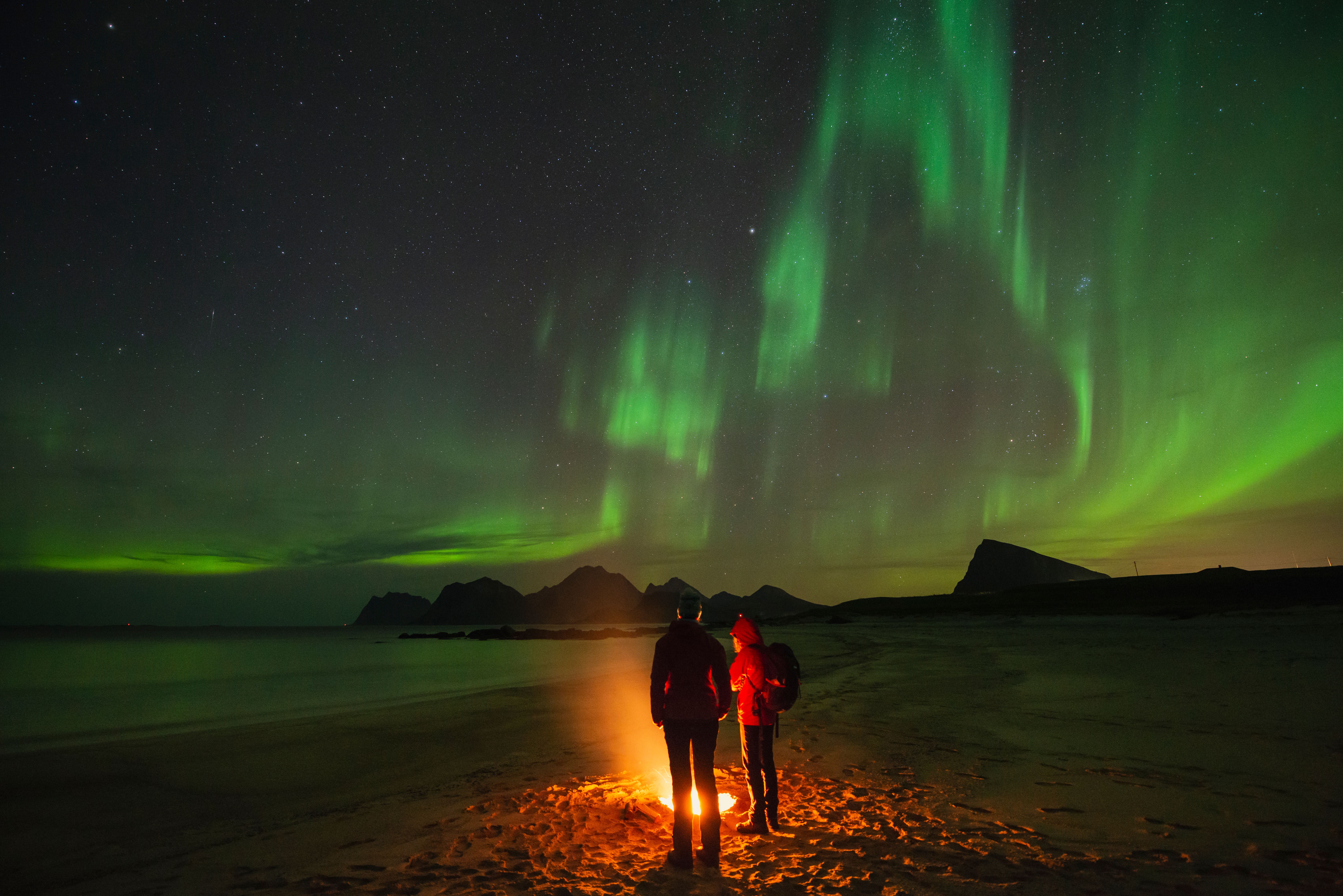 Northern Lights by open fire, Lofoten, Norway